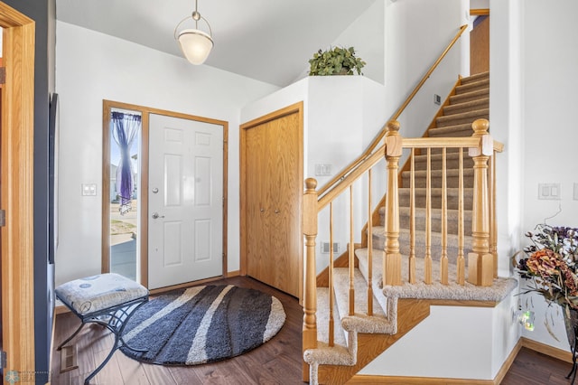 entryway featuring visible vents, baseboards, stairs, and wood finished floors