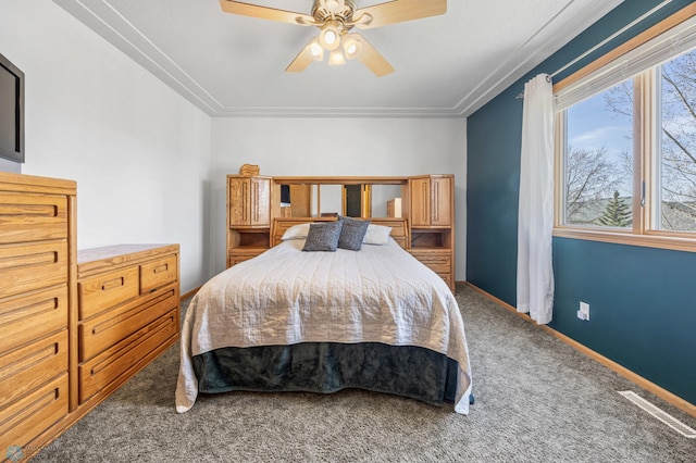 carpeted bedroom with a ceiling fan and baseboards
