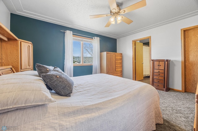 carpeted bedroom with a textured ceiling and ceiling fan