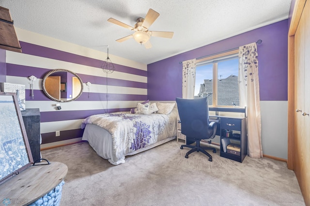 carpeted bedroom with baseboards, a ceiling fan, and a textured ceiling