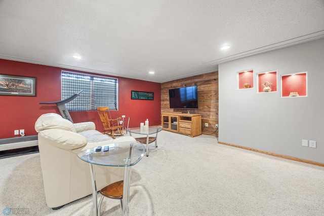 carpeted living room featuring recessed lighting, baseboards, wood walls, and an accent wall