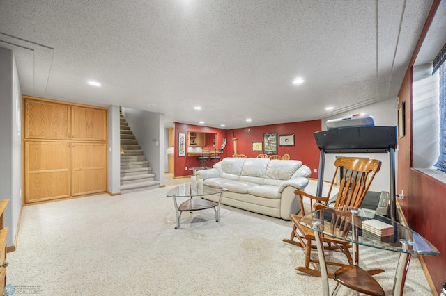 living area with stairway, recessed lighting, and a textured ceiling