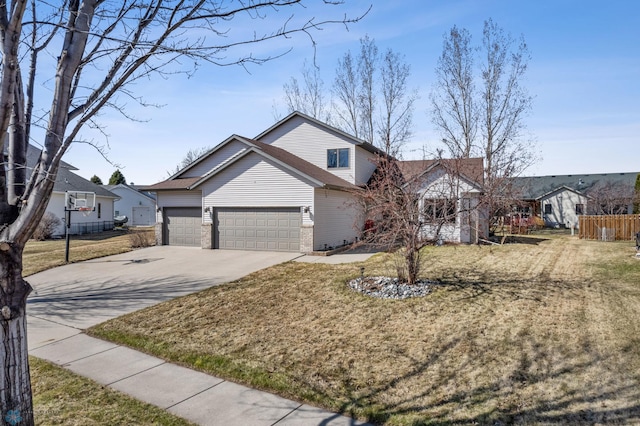 traditional home featuring fence, brick siding, a garage, a front yard, and driveway
