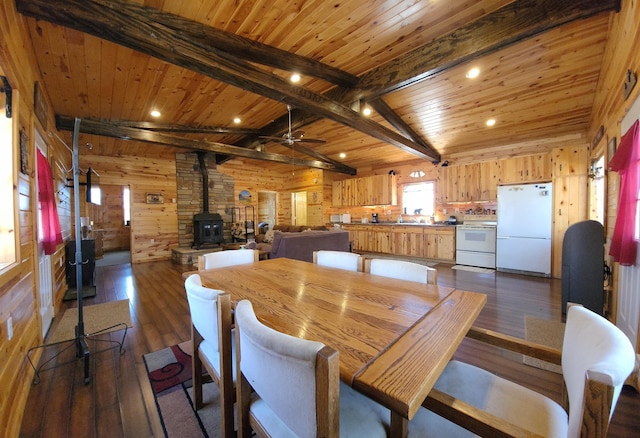 5227 Hyland Rd SW, Motley, MN 56466 - dining space with dark wood-style flooring, ceiling fan, a wood stove, wood walls, and wooden ceiling