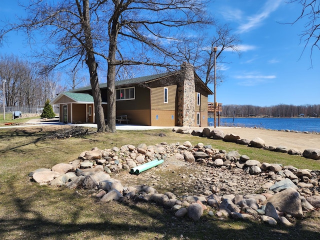 5227 Hyland Rd SW, Motley, MN 56466 - view of side of property featuring a water view, a chimney, and a garage