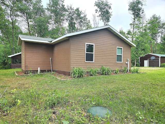 5227 Hyland Rd SW, Motley, MN 56466 - view of home's exterior featuring a yard, a sunroom, a garage, and an outdoor structure