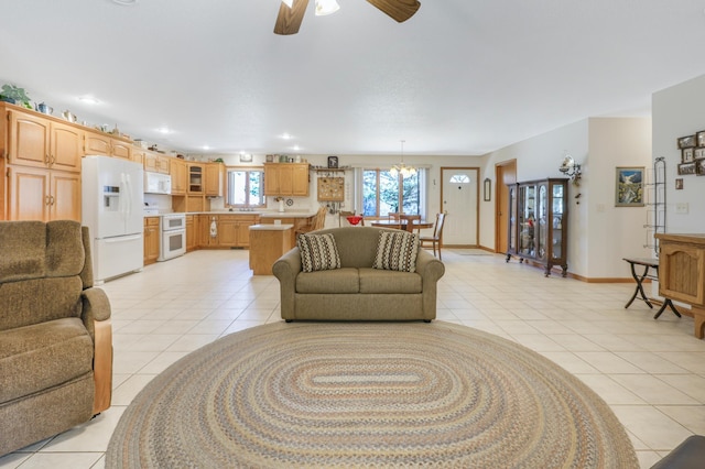 living area featuring light tile patterned floors, ceiling fan, recessed lighting, and baseboards