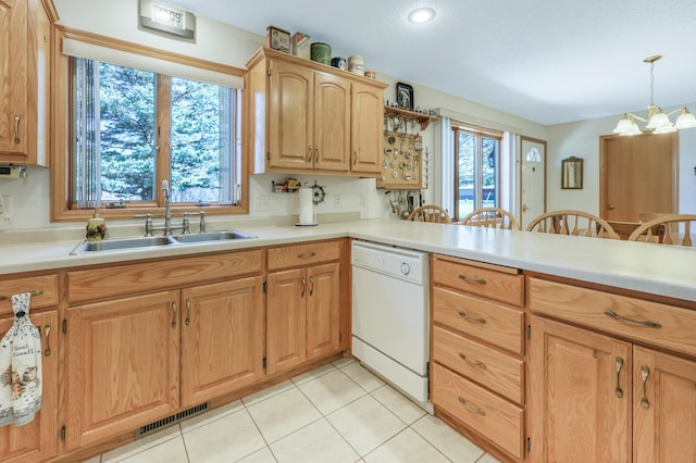 kitchen with a sink, visible vents, light countertops, white dishwasher, and an inviting chandelier