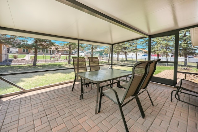 sunroom / solarium featuring outdoor dining area
