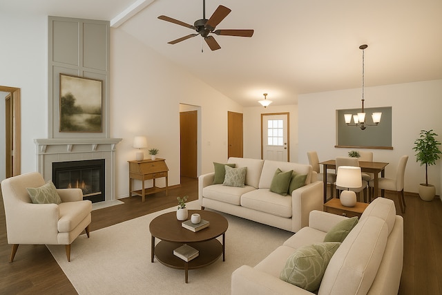 living room with beam ceiling, wood finished floors, a tiled fireplace, a ceiling fan, and a chandelier