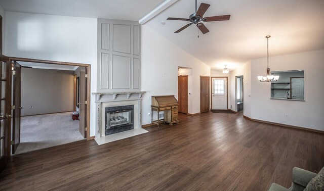 unfurnished living room with a ceiling fan, a premium fireplace, high vaulted ceiling, a chandelier, and beamed ceiling