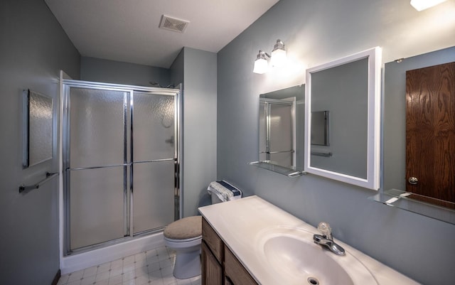 full bath with a stall shower, toilet, tile patterned floors, and vanity
