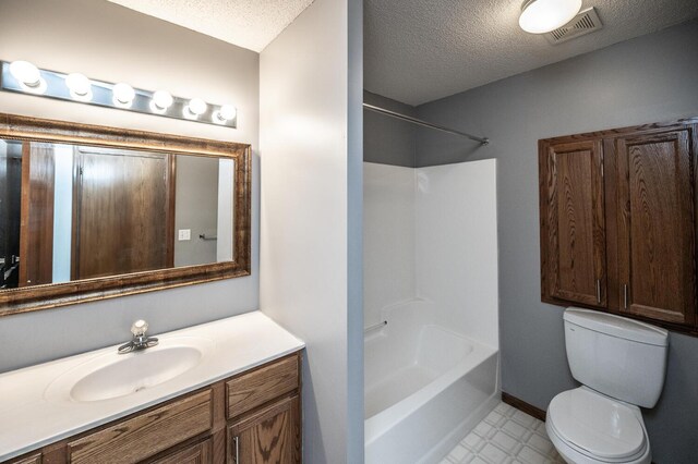 bathroom with toilet, a textured ceiling, vanity, bathtub / shower combination, and baseboards