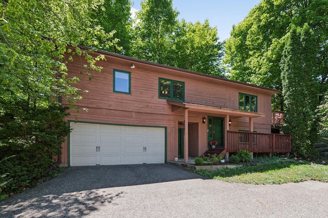 view of front facade featuring a garage, driveway, and a porch