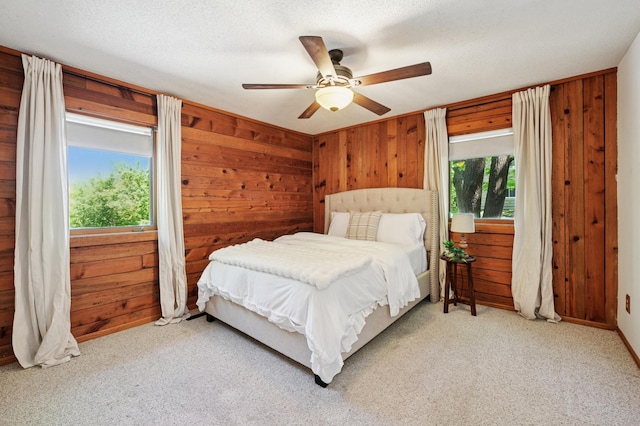 3021 Devon Ln, Mound, MN 55364 - carpeted bedroom featuring wooden walls and a ceiling fan