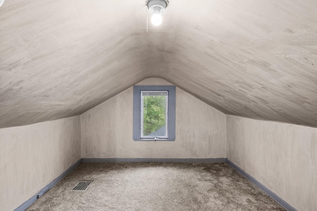 bonus room featuring baseboards, carpet, vaulted ceiling, and visible vents