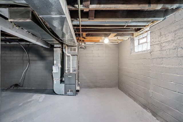 basement featuring heating unit and visible vents