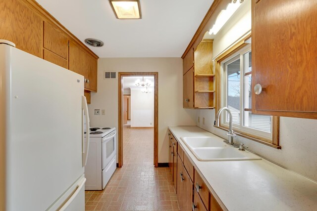 kitchen with a sink, white appliances, light countertops, brick patterned floor, and visible vents