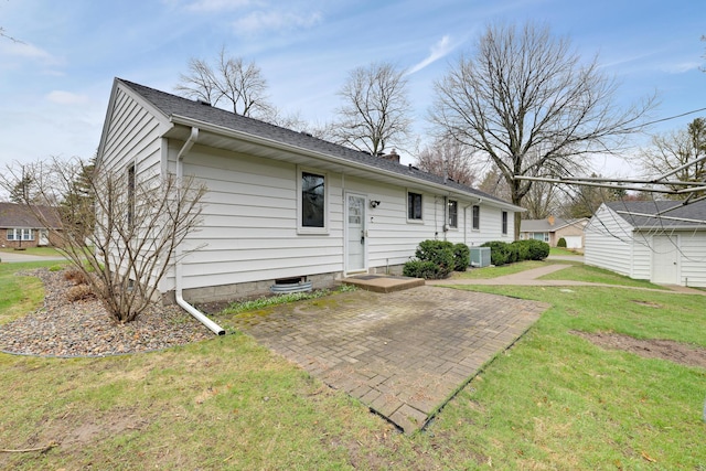 view of front facade featuring central air condition unit, a chimney, a patio area, and a front lawn