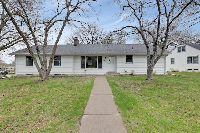 ranch-style home featuring a front lawn, roof with shingles, and a chimney