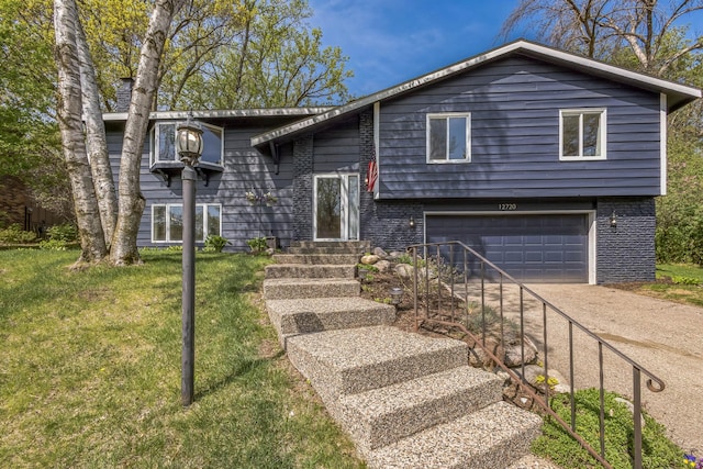 12720 Parkwood Dr, Burnsville, MN 55337 - view of front of property with an attached garage, concrete driveway, and a front lawn