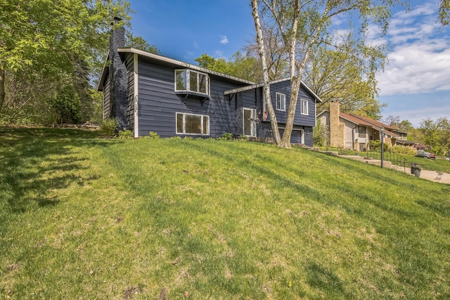 12720 Parkwood Dr, Burnsville, MN 55337 - rear view of house featuring a yard and a chimney
