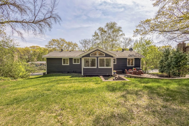 12720 Parkwood Dr, Burnsville, MN 55337 - rear view of house with a lawn, a patio, and a shingled roof
