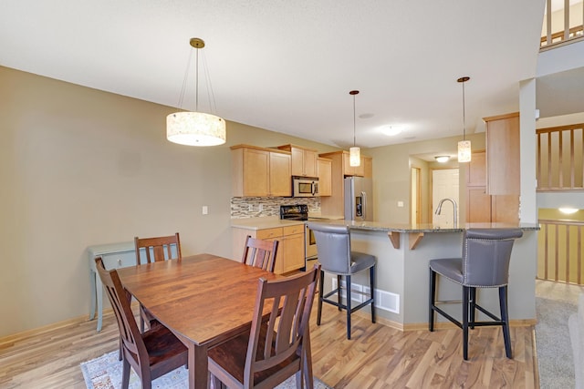 dining area with light wood-type flooring