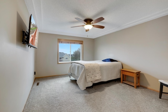 bedroom featuring carpet floors, baseboards, a textured ceiling, and visible vents