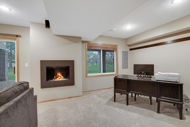 carpeted home office featuring recessed lighting, baseboards, plenty of natural light, and a warm lit fireplace