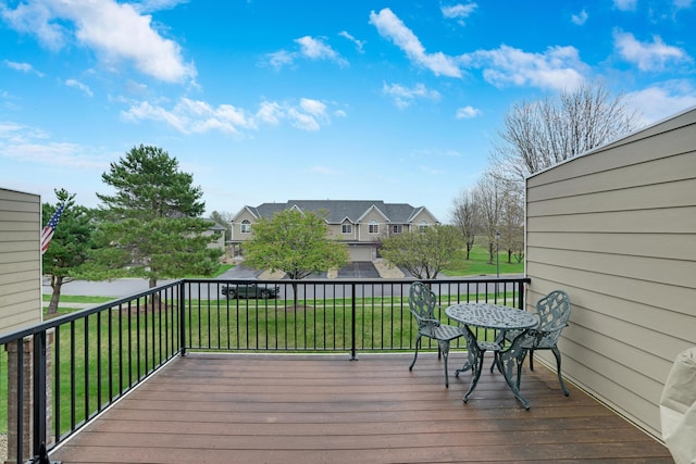 wooden deck with a lawn