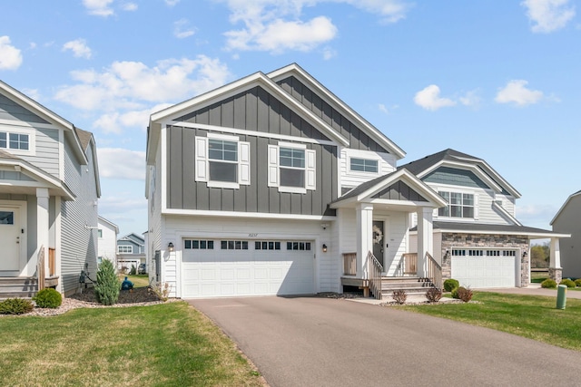 10257 Greenway Cir S, Cottage Grove, MN 55016 - view of front of house with board and batten siding, a garage, asphalt driveway, and a front yard
