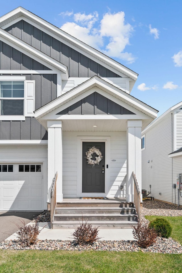 10257 Greenway Cir S, Cottage Grove, MN 55016 - view of front facade with board and batten siding, a garage, a porch, and driveway