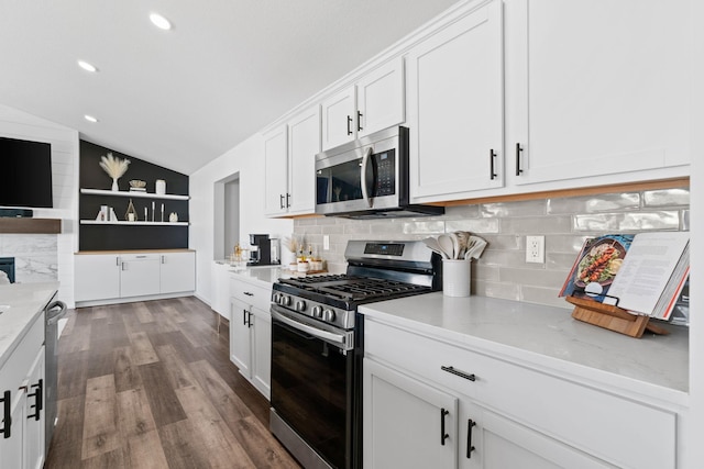 10257 Greenway Cir S, Cottage Grove, MN 55016 - kitchen with appliances with stainless steel finishes, vaulted ceiling, white cabinets, decorative backsplash, and dark wood-type flooring