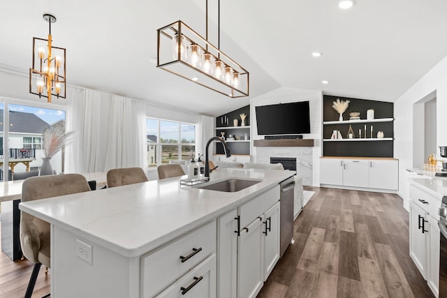 10257 Greenway Cir S, Cottage Grove, MN 55016 - kitchen featuring a sink, dishwasher, vaulted ceiling, wood finished floors, and a fireplace