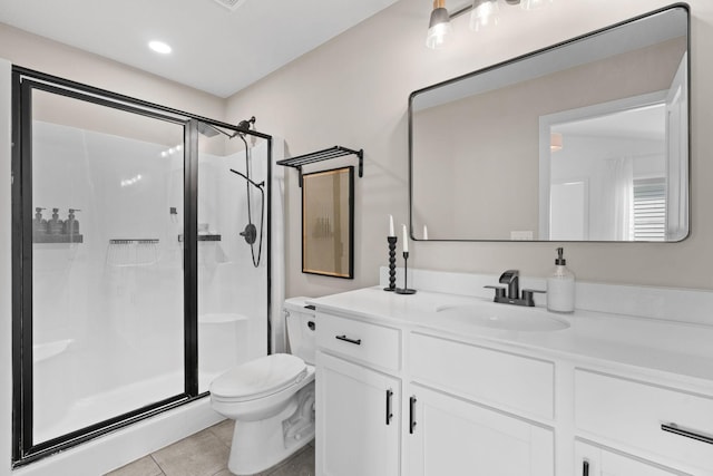 10257 Greenway Cir S, Cottage Grove, MN 55016 - bathroom featuring toilet, a stall shower, vanity, tile patterned floors, and recessed lighting