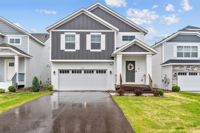 10257 Greenway Cir S, Cottage Grove, MN 55016 - craftsman-style house with board and batten siding, a front yard, asphalt driveway, and a garage