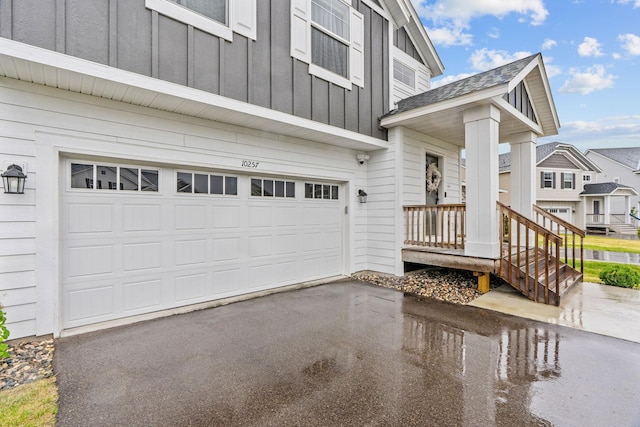 10257 Greenway Cir S, Cottage Grove, MN 55016 - property entrance featuring a garage, board and batten siding, and driveway