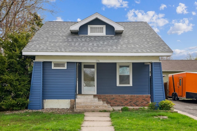 1170 11th Ave, Baldwin, WI 54002 - view of front facade with brick siding, a shingled roof, and a front lawn