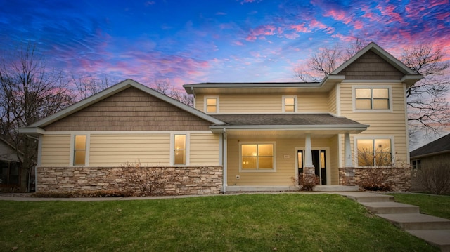 3219 Anric Dr, Eau Claire, WI 54701 - view of front of house with a lawn, covered porch, and stone siding