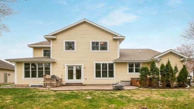 3219 Anric Dr, Eau Claire, WI 54701 - back of property featuring a yard, a patio, a hot tub, and roof with shingles