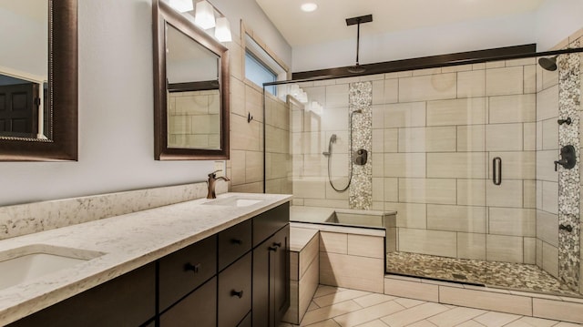 3219 Anric Dr, Eau Claire, WI 54701 - full bath featuring double vanity, tile patterned floors, a shower stall, and a sink