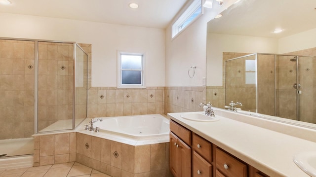 3219 Anric Dr, Eau Claire, WI 54701 - bathroom featuring tile patterned flooring, a garden tub, double vanity, a sink, and a stall shower