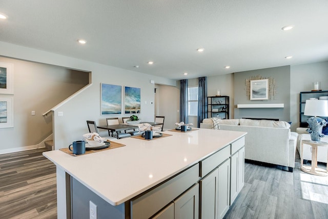 17240 Durham Dr, Lakeville, MN 55044 - kitchen with light countertops, recessed lighting, open floor plan, wood finished floors, and a kitchen island