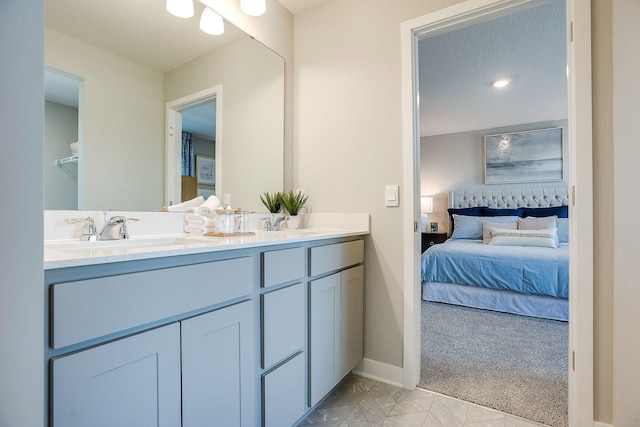 17240 Durham Dr, Lakeville, MN 55044 - ensuite bathroom featuring double vanity, tile patterned flooring, a sink, baseboards, and ensuite bath