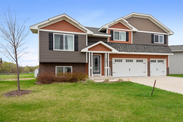 view of front of home with an attached garage, roof with shingles, driveway, and a front yard