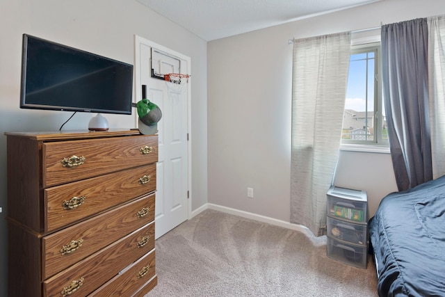 carpeted bedroom featuring baseboards