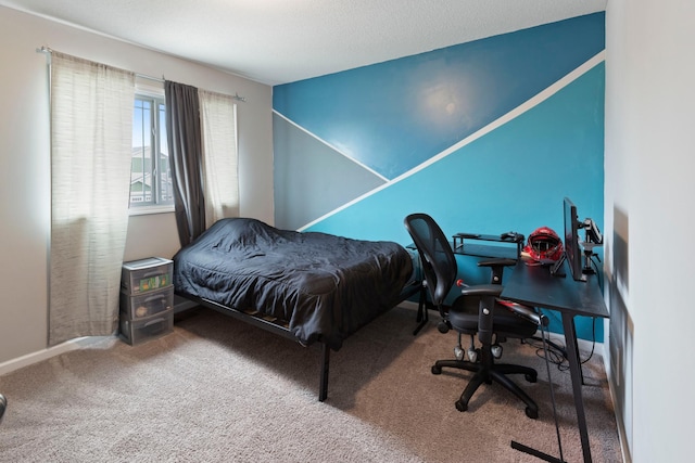 bedroom featuring baseboards and carpet