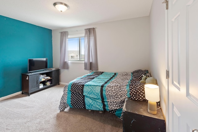 bedroom with baseboards and carpet