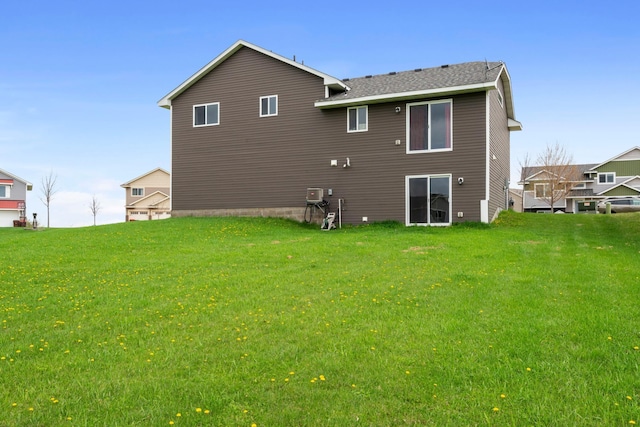 back of property featuring a lawn